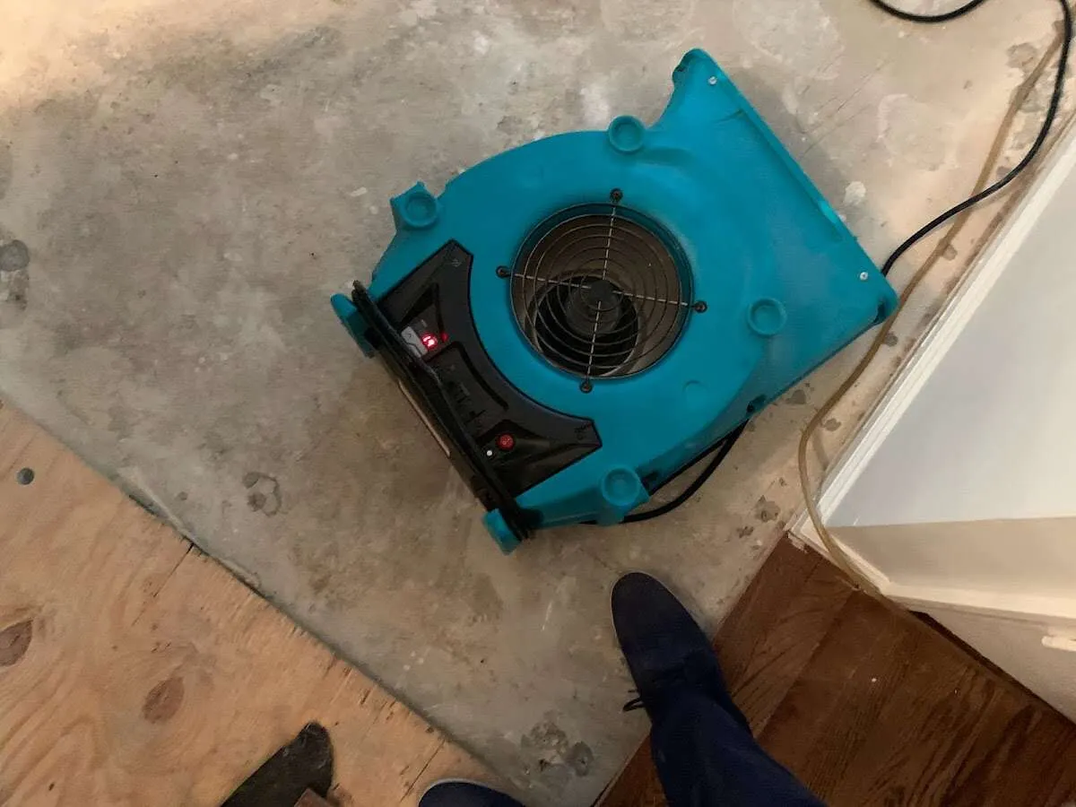 Air mover drying subfloor during Commercial Water Damage Restoration in Atascocita